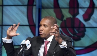 FILE - In this June 4, 2013, file photo, Toronto Raptors new general manager Masai Ujiri gestures during an NBA basketball news conference in Toronto. Raptors general manager Ujiri let loose a profanity during a pregame address meant to pump up a group of Raptors fans outside Air Canada Centre before a Saturday, April 19, 2014, opening game of the NBA playoffs. (AP Photo/The Canadian Press, Nathan Denette, File)