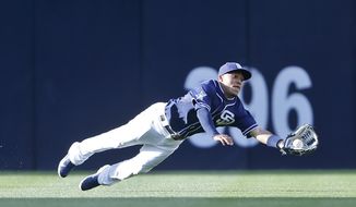 San Diego Padres center fielder Alexi Amarista makes a diving catch to rob San Francisco Giants&#x27; Hunter Pence in the first inning of a baseball game Saturday, April 19, 2014, in San Diego.  (AP Photo/Lenny Ignelzi)