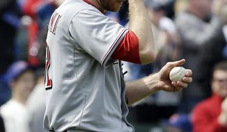 Cincinnati Reds starter Tony Cingrani wipes his face after Chicago Cubs&#39; Mike Olt hit a solo home run during the second inning of a baseball game in Chicago, Saturday, April 19, 2014. (AP Photo/Nam Y. Huh)