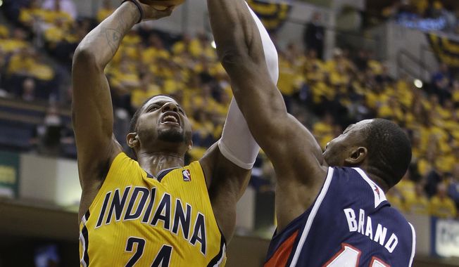 Indiana Pacers&#x27; Paul George (24) shootsagainst Atlanta Hawks&#x27; Elton Brand during the second half in Game 1 of an opening-round NBA basketball playoff series on Saturday, April 19, 2014, in Indianapolis. Atlanta defeated Indiana 101-93. (AP Photo/Darron Cummings)