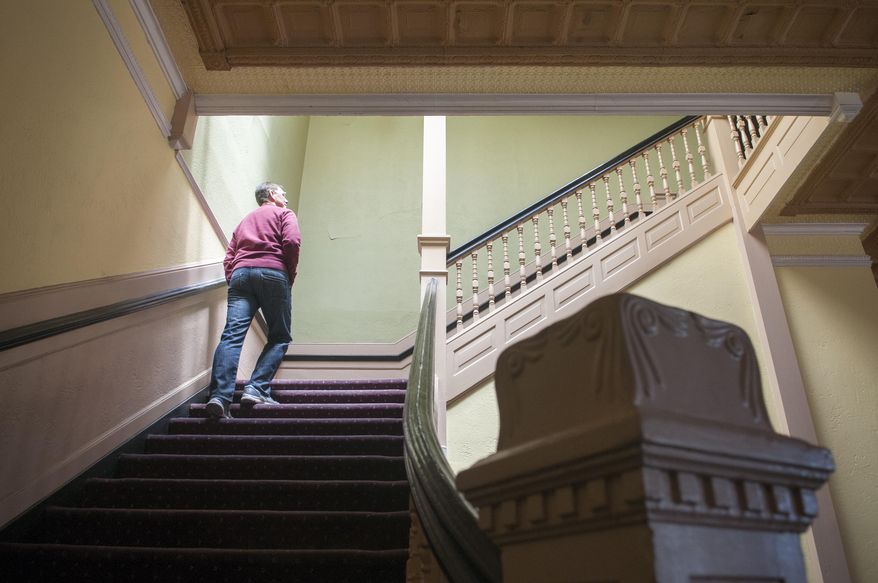 Allan Affeldt walks up the stairs of his century-old La Castaneda Hotel in Las Vegas, N.M. on Tuesday, April 8, 2014. He purchased the property in April 2014 and plans to restore the hotel which was originally built in 1898 to serve as food-and-rest stop along the Santa Fe Railway. (AP Photo/Albuquerque Journal, Eddie Moore)