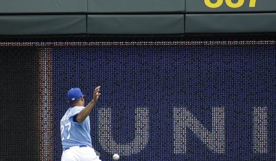 Kansas City Royals right fielder Justin Maxwell chases a two-run double by Minnesota Twins' Trevor Plouffe during the first inning of a baseball game on Sunday, April 20, 2014, at Kauffman Stadium in Kansas City, Mo. (AP Photo/Charlie Riedel)