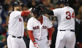 Boston Red Sox&#x27;s David Ortiz (34) and Mike Napoli, left, celebrate after scoring a on a three-run home run by Jonny Gomes, center, in the sixth inning of a baseball game against the Baltimore Orioles in Boston, Sunday, April 20, 2014. (AP Photo/Michael Dwyer)