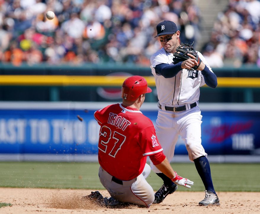 Detroit Tigers second baseman Ian Kinsler, right, turns the ball after getting a force out on Los Angeles Angels' Mike Trout, in the sixth inning of a baseball game Sunday, April 20, 2014, in Detroit. Kinsler made the double play, throwing out Albert Pujols at first. (AP Photo/Duane Burleson