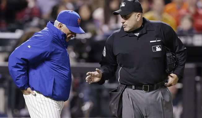 New York Mets manager Terry Collins argues a call with home plate umpire Eric Cooper during the third inning of a baseball game against the Atlanta Braves on Saturday, April 19, 2014, in New York. (AP Photo/Frank Franklin II)