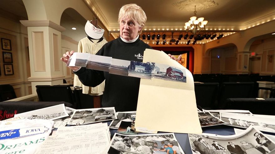 In this April 16, 2014 photo, Iowa casting coordinator Sue Riedel shows the photos of Don Lansing's Dyersville farm that she sent to the production company looking for an iconic farm to use for the film Field of Dreams. Riedel's solo scouting trip in 1987 was a fateful moment for these 193 acres, which for the last quarter century have been home to the rural baseball diamond known as the Field of Dreams. (AP Photo/The Des Moines Register, Rodney White)