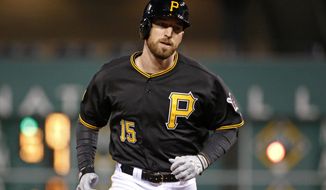 Pittsburgh Pirates&#x27; Ike Davis (15) rounds the bases after hitting his first home run since being acquired from the New York Mets this past week,  a grand slam off Cincinnati Reds starting pitcher Mike Leake during the fourth inning of a baseball game in Pittsburgh Monday, April 21, 2014. (AP Photo/Gene J. Puskar)