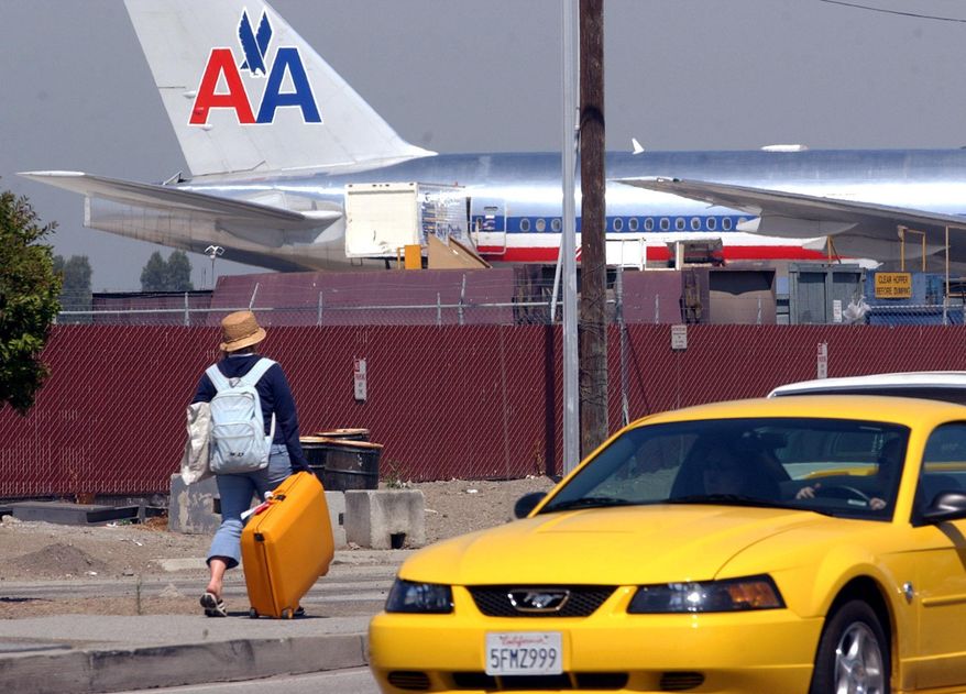 File- This July 2, 2004, file photo shows a traveler walking from one terminal to another at San Jose Airport in San Jose, Calif. FBI officials say a 16-year-old boy stowed away in the wheel well of a flight from California to Hawaii, surviving the trip halfway across the Pacific Ocean unharmed despite frigid. Security footage from the San Jose airport verified that the boy hopped a fence to get to Hawaiian Airlines Flight 45 on Sunday April 20, 2014. (AP Photo/Paul Sakuma, File)