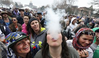 Smokin&#39;: Cannabis lovers revel in the freedom to smoke marijuana during the 4/20 festival this weekend in Denver. It was the first time the annual celebration was held since Colorado legalized pot for recreational use. On Monday, however, state lawmakers moved to tighten rules on marijuana products in the wake of two tragic deaths thought to be related to the drug. Story, A5. (Associated Press photographs)