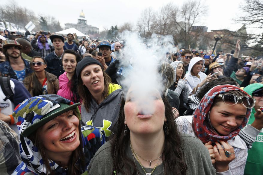 Smokin&#x27;: Cannabis lovers revel in the freedom to smoke marijuana during the 4/20 festival this weekend in Denver. It was the first time the annual celebration was held since Colorado legalized pot for recreational use. On Monday, however, state lawmakers moved to tighten rules on marijuana products in the wake of two tragic deaths thought to be related to the drug. Story, A5. (Associated Press photographs)