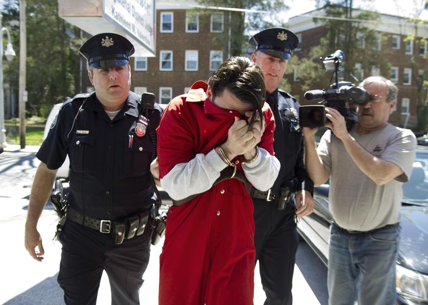 Neil K. Scott covers his face as he is led into Montgomery County Magisterial District Court, Monday, April 21, 2014, in Montgomery County, Pa. Montgomery County prosecutors identified Scott as one of the leaders of a drug ring they say supplied marijuana and cocaine to three colleges and a number of high schools in Philadelphia's affluent Main Line suburbs. Scott and the other suspect, Timothy Brooks, were both graduates of The Haverford School. (AP Photo/The Philadelphia Inquirer, Clem Murray) PHIX OUT; TV OUT; MAGS OUT; NEWARK OUT