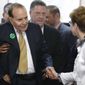 Former Sen. Bob Dole, R-Kan., second from left, greets former Mission Mayor Laura McConwell, right, at Johnson County Republican Headquarters in Overland Park, Kan., Monday, April 21, 2014. (AP Photo/Orlin Wagner)