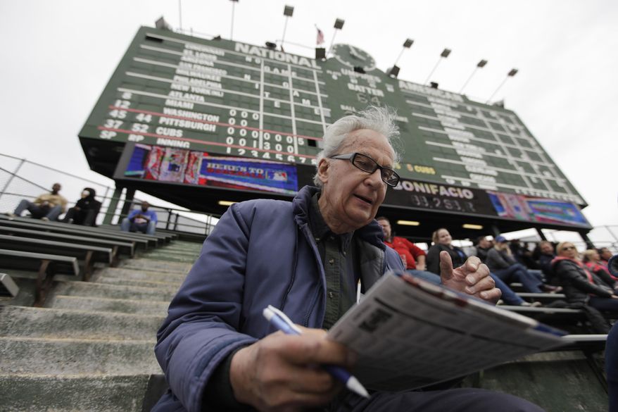 In this April 10, 2014 photo, John Weber keeps score with a pencil and scorecard as he watches a baseball game between Pittsburgh Pirates and Chicago Cubs at Wrgley Field Thursday, in Chicago. The 86-year-old retired transit worker figures he is an increasingly rare kind of baseball fan. Between batters and between pitches, most fans in the stands at Wrigley _ and everywhere else in the majors _ take their eyes off the game to peck away at smartphones, not bothering to try to figure out the baseball hieroglyphics that Weber and other purists scrawl on their cards. (AP Photo/Kiichiro Sato)