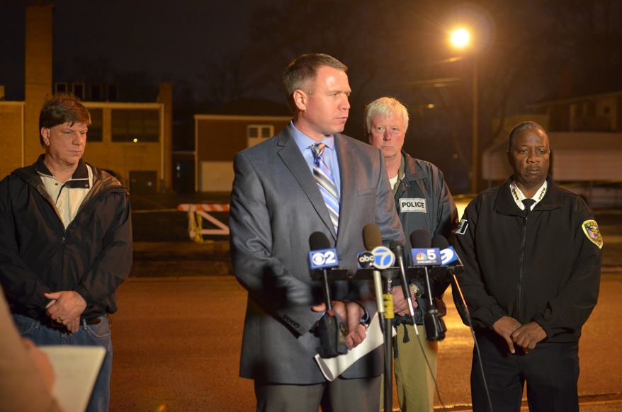 In this photo taken April 21, 2014, Griffith Police Chief Greg Mance, center, speaks to the media about a shooting that occurred earlier on the property of St. Mary's School in Griffith, Ind. Behind him from left is Griffith Town Councilman Rick Ryfa, Griffith Detective Lt. Matt Argadine, Gary Police Chief Wade Ingram. Nina Castro, 42, was shot to death by her estranged husband, Remanard Castro, 55, who later died of a self-inflicted gunshot wound at his home after a police officer confronted him, police said. (AP Photo/The Times, Jeff Dildine) MANDATORY CREDIT; CHICAGO LOCALS OUT; GARY OUT.