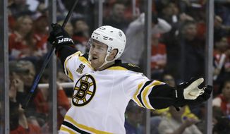 Boston Bruins defenseman Dougie Hamilton reacts after scoring during the first period of Game 3 of a first-round NHL hockey playoff series against the Detroit Red Wings in Detroit, Tuesday, April 22, 2014. (AP Photo/Carlos Osorio)