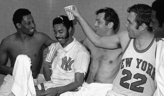 Dave DeBusschere (22) pours beer over Walt Frazier after the New York Knickers Bocker players beat the Milwaukee Ducks 132-96 in Madison Square Garden April 20,1970 putting them into the NBA Championship playoffs. Others are, Bill Bradley, center, and Cazzie Russel right. (AP Photo)