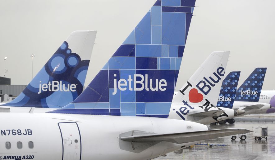JetBlue airplanes at their gates at John F. Kennedy Airport in New York, Wednesday, Nov. 27, 2013. (AP Photo/Seth Wenig)