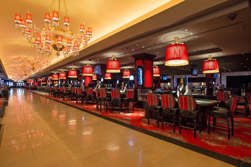 This April 21, 2014 photo provided by The Cromwell shows dealers waiting at their tables at The Cromwell Hotel and Casino. Slot machines are now ringing at the boutique hotel replacing Bill's Gamblin' Hall & Saloon in the heart of the Las Vegas Strip. The Cromwell celebrated its soft opening Monday evening, April 21, 2014 by welcoming guests into a 40,000-square-foot casino featuring 434 slot machines and 66 table games. The hotel's 188 rooms and suites are not accepting guests until May 21, but the gambling area, the Interlude cocktail lounge and the Curios retail shop are open for business. (AP Photo/The Cromwell, Erik Kabik)