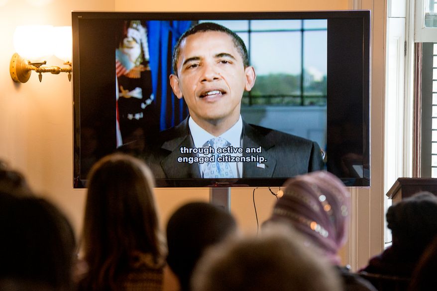 Children watch a video message from President Barack Obama after taking their Naturalization Oath of Allegiance at Lincoln's Cottage, Washington, D.C., Tuesday, April 22, 2014. Twenty area children representing 15 countries receive their Certificates of Citizenship during a special ceremony at President Lincoln's Cottage, where it is believed President Abraham Lincoln drafted the Emancipation Proclamation. (Andrew Harnik/The Washington Times)