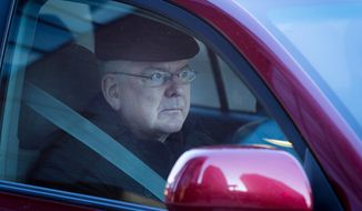 In this photo taken on Wednesday, April 2, 2014, Archbishop John Nienstedt, leader of the Archdiocese of St. Paul and Minneapolis, rides in a vehicle in St. Paul, Minn., on his way to giving a deposition. Attorneys for victims of alleged sexual abuse by priests are releasing the deposition of Nienstedt. It was the first time since he became archbishop six years ago that he has had to answer these questions under oath. The deposition was taken as part of a lawsuit filed by a man who claims a priest abused him in the 1970s. (AP Photo/Minnesota Public Radio,  Jennifer Simonson) MANDATORY CREDIT