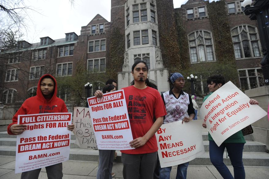Jose Alvarenga, center, BAMN (By Any Means Necessary) national organizer, and others protest the Supreme Court ruling on the campus of the University of Michigan Tuesday, April 22, 2014, in Ann Arbor, Mich. The justices ruled 6-2 that Michigan voters had the right to change their state constitution in 2006 to prohibit public colleges and universities from taking account of race in admissions decisions. (AP Photo/Detroit News, David Coates ) DETROIT FREE PRESS OUT; HUFFINGTON POST OUT, MANDATORY CREDIT