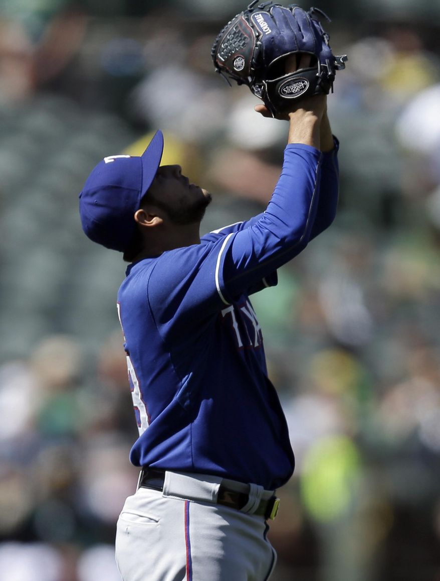 Texas Rangers' Martin Perez celebrates at the end of a baseball game against the Oakland Athletics, Wednesday, April 23, 2014, in Oakland, Calif. Perez pitched his second consecutive shutout to extend his scoreless innings streak to 26, giving Texas a 3-0 win. (AP Photo/Ben Margot)