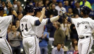 Milwaukee Brewers&#39; Jean Segura (9) is congratulated by teammates Lyle Overbay (24), Khris Davis (18) and Kyle Lohse after hitting a three-run home run during the second inning of a baseball game against the San Diego Padres, Wednesday, April 23, 2014, in Milwaukee. (AP Photo/Morry Gash)