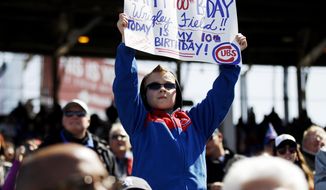 Jake Schrum, 10, of Cedar Lake, Ind., holds a sign during the fifth inning of a baseball game between the Chicago Cubs and the Arizona Diamondbacks at Wrigley Field in Chicago on Wednesday, April 23, 2014. (AP Photo/Andrew A. Nelles)