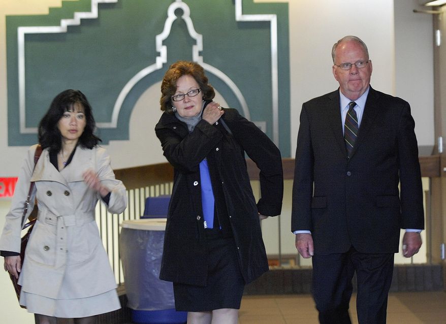 Former Illinois State University President Timothy Flanagan and his wife, Nancy, walk through the lobby of the McLean County Law and Justice Center in Bloomington, Ill., with his attorney Stephanie Wong, left, after he pleaded not guilty to a disorderly conduct charge Wednesday, April 23, 2014. The charge stems from an alleged altercation between Flanagan and a grounds crew worker outside of the university-owned presidents' residence on Dec. 5. Flanagan has acknowledged yelling at the employee but denies he spat on or made contact with the man. (AP Photo/The Pantagraph, Lori Ann Cook-Neisler)