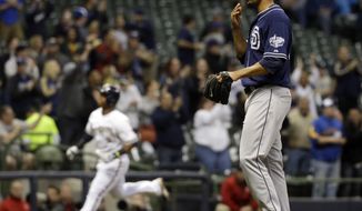 San Diego Padres starting pitcher Tyson Ross, right, waits for a ball as Milwaukee Brewers&#39; Jean Segura rounds the bases after hitting a three-run home run during the second inning of a baseball game on Wednesday, April 23, 2014, in Milwaukee. (AP Photo/Morry Gash)