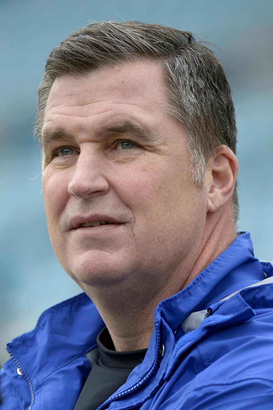 In this Dec. 15, 2013, photo, Buffalo Bills coach Doug Marrone watches players warm up for NFL football game between the Jacksonville Jaguars and the Bills in Jacksonville, Fla. Marrone said Tuesday night, April 22, 2014, he had a cancerous mole removed, and added it will not have any effect on him doing his job. Marrone made the announcement in a statement released through the team. (AP Photo/Phelan M. Ebenhack)
