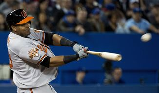 Baltimore Orioles&#39; Nelson Cruz hits a grand slam against the Toronto Blue Jays during fifth-inning baseball game action in Toronto, Wednesday, April 23, 2014. (AP Photo/The Canadian Press, Nathan Denette)
