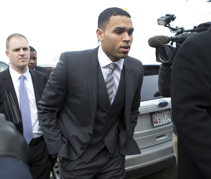 FILE - This Jan. 8, 2014 file photo shows singer Chris Brown, right, arriving at the District of Columbia Superior Court in Washington. After a brief postponement, singer Chris Brown's trial on an assault charge is scheduled to begin in Washington. Brown's trial had been set for Monday but was delayed while lawyers tried to work out whether his bodyguard will testify. It's unclear whether the trial will start Wednesday, as Brown's lawyers seem to want, or if further legal maneuvering will delay it. (AP Photo/Manuel Balce Ceneta, File)