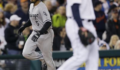 Chicago White Sox's Marcus Semien rounds the bases after his grand slam as Detroit Tigers relief pitcher Ian Krol walks back to the mound during the seventh inning of a baseball game in Detroit, Wednesday, April 23, 2014. (AP Photo/Carlos Osorio)