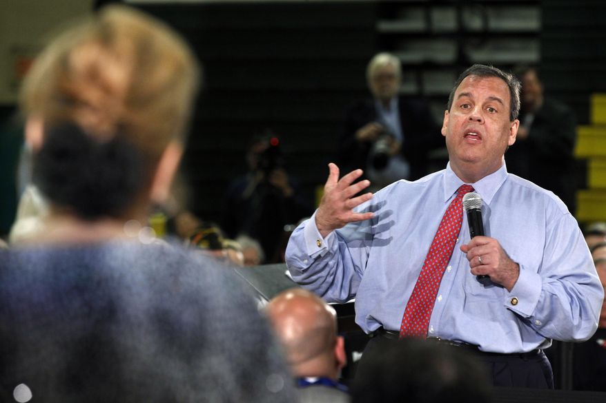 New Jersey Gov. Chris Christie answers a question from Carol Raab Davis of Toms River, during a town hall meeting in Brick Township, N.J., Thursday, April 24, 2014. Many questions at the town hall focused on the state's Sandy recovery efforts. (AP Photo/Mel Evans)