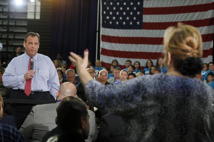 New Jersey Gov. Chris Christie listens to Carol Raab Davis of Toms River, during a town hall meeting in Brick Township, N.J., Thursday, April 24, 2014. Many questions at the town hall focused on the state's Sandy recovery efforts. (AP Photo/Mel Evans)