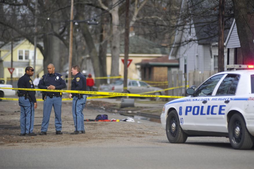 Muskegon Heights Police investigate a shooting on Rotterdam Avenue in Muskegon Heights, Mich around 5:30 p.m. on Wednesday, April 23, 2014. Authorities say Marquis Gresham, 17, a high school basketball player, has died following the drive-by shooting Wednesday night. Gresham was a junior at Muskegon Heights Public School Academy and a starting center on the Tigers' varsity basketball team.(AP Photo/The Muskegon Chronicle, ) ALL LOCAL TV OUT; LOCAL TV INTERNET OUT