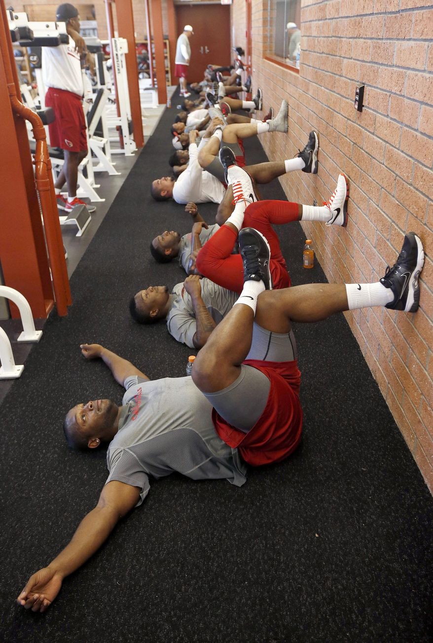Arizona Cardinals&#x27; Jonathan Dwyer,Tony Jefferson and Stepfan Taylor, from front, work out with teammates during the first phase of the voluntary offseason training program at the NFL football team&#x27;s training facility Thursday, April 24, 2014, in Tempe, Ariz. (AP Photo/Ross D. Franklin)