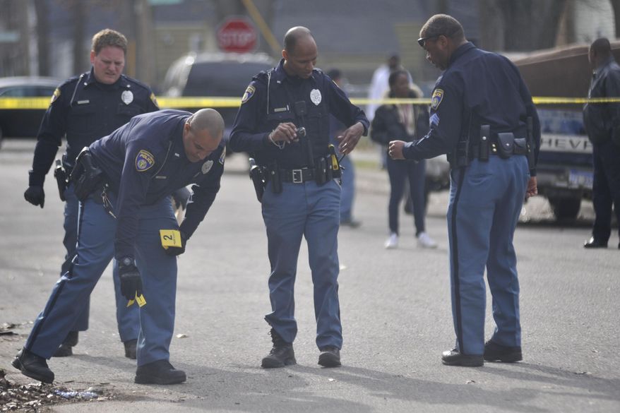 Muskegon Heights Police investigate a shooting on Rotterdam Avenue near the intersection of Fifth Street in Muskegon Heights around 5:30 p.m. on Wednesday, April 23, 2014. Authorities say Marquis Gresham, 17, has died following the drive-by shooting Wednesday night. Gresham was a junior at Muskegon Heights Public School Academy and a starting center on the Tigers' varsity basketball team.(AP Photo/The Muskegon Chronicle, ) ALL LOCAL TV OUT; LOCAL TV INTERNET OUT