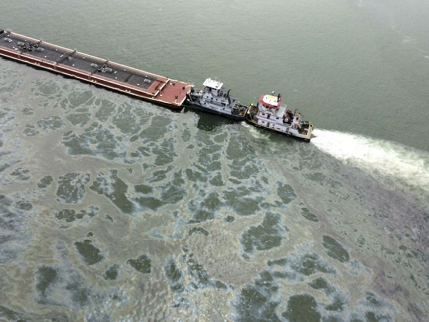 File - In this March 22, 2014 file photo, a barge loaded with marine fuel oil sits partially submerged in the Houston Ship Channel. The owner of a tugboat that collided with a ship last month, dumping nearly 170,000 gallons of oil into the Houston Ship Channel, claims in court filings the ship was speeding and being operated in a reckless manner. Houston-based Kirby Inland Marine alleges in court documents filed earlier this month that the March 22 collision, which occurred after the ship struck a barge the tugboat had been pulling, was caused by gross negligence on the part of the ship’s owner, Liberia-based Sea Galaxy Marine. In its own court filings, Sea Galaxy says the collision was not its fault. (AP Photo/U.S. Coast Guard, PO3 Manda Emery, File)