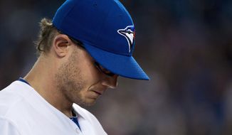 Toronto Blue Jays pitcher Brett Cecil, looks down as he walks back to the dugout after allowing two runs to the Baltimore Orioles during the seventh inning of a baseball game in Toronto on Thursday, April 24, 2014. (AP Photo/The Canadian Press, Nathan Denette)