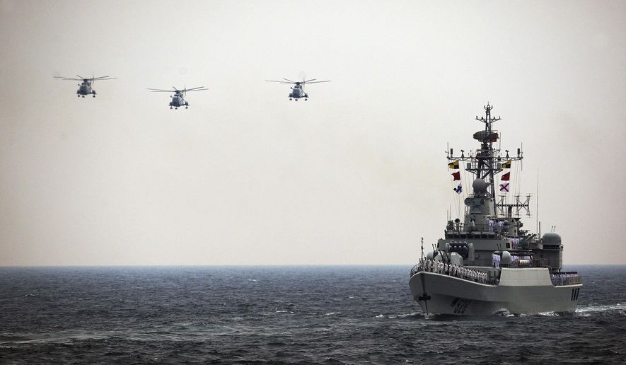 In this April 23, 2009 photo, Chinese Navy helicopters and 528 warship attend an international fleet review to celebrate the 60th anniversary of the founding of the People&#39;s Liberation Army Navy in the water off Qingdao of Shandong Province, China. China’s boosted defense spending this year grew 12.2 percent to $132 billion, continuing more than two decades of nearly unbroken double-digit percentage increases that have afforded Beijing the means to potentially alter the balance of power in the Asia-Pacific. Outside observers put China’s actual defense spending significantly higher, although estimates vary widely.  (AP Photo/Guang Niu, Pool)