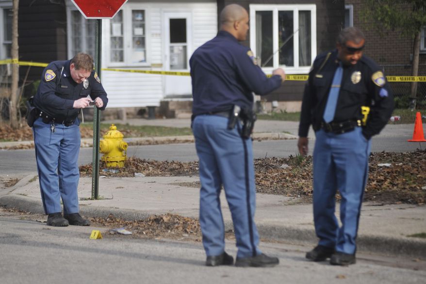 Muskegon Heights Police investigate a shooting on Rotterdam Avenue in Muskegon Heights, Mich around 5:30 p.m. on Wednesday, April 23, 2014. Authorities say Marquis Gresham, 17, a high school basketball player, has died following the drive-by shooting Wednesday night. Gresham was a junior at Muskegon Heights Public School Academy and a starting center on the Tigers' varsity basketball team.(AP Photo/The Muskegon Chronicle, ) ALL LOCAL TV OUT; LOCAL TV INTERNET OUT