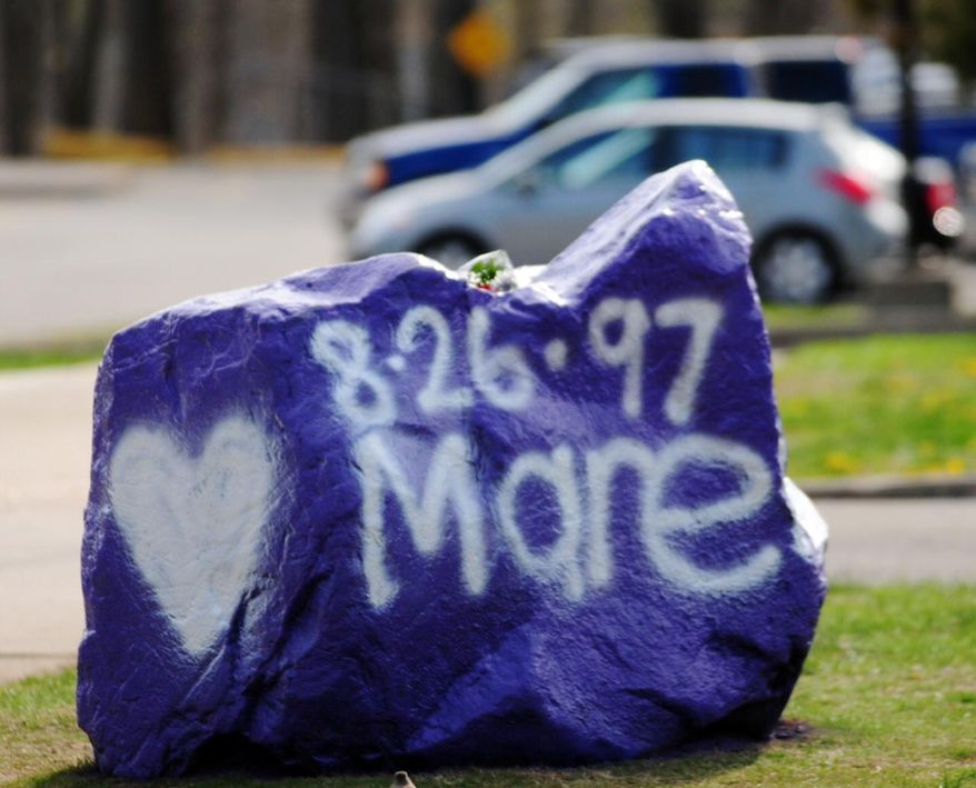 A rock spray-painted by students sits in memory of 16-year-old stabbing victim Maren Sanchez on Friday, April 25, 2014, sits outside Jonathan Law High School in Milford, Conn. Sanchez was stabbed to death earlier during an altercation inside the school. A teenage boy is in custody, and police are investigating whether she was stabbed because she declined to be his date at the junior prom. (AP Photo/The New Haven Register, Peter Hvizdak) MANDATORY CREDIT