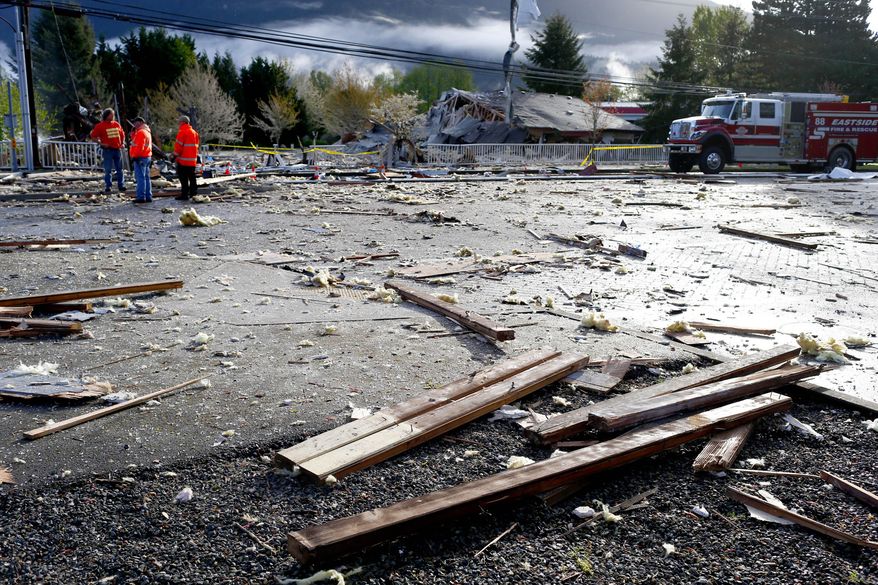 Debris is strewn over the roadway at the scene of a large explosion in North Bend, Wash., on Friday, April 25, 2014. A big explosion and fire destroyed three buildings, damaged several others, sent debris flying for blocks and jolted people awake early Friday, firefighters and North Bend residents said. (AP Photo/The Seattle Times, John Lok) SEATTLE OUT; USA TODAY OUT; MAGS OUT; TELEVISION OUT; NO SALES; MANDATORY CREDIT TO BOTH THE SEATTLE TIMES AND THE PHOTOGRAPHER