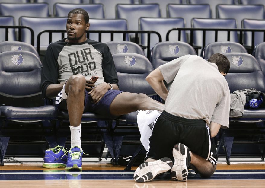 Oklahoma City Thunder forward Kevin Durant gets his ankle treated during practice Friday, April 25, 2014, in Memphis, Tenn. The Thunder face the Memphis Grizzlies on Saturday in Game 4 of their opening-round NBA basketball playoff series. The Grizzlies lead the series 2-1. (AP Photo/Mark Humphrey)