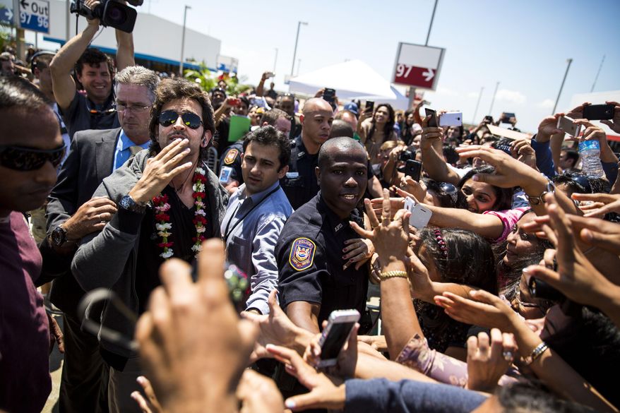 Actor Hrithik Roshan greets fans and well-wishers after arriving on the green carpet on the ninth floor of the parking garage at Tampa International Airport for the 15th International Indian Film Academy Awards on Thursday, April 24, 2014 in Tampa, Fla. Roshan is billed as "one of the worlds greatest dancers", and the main awards shows biggest performer. (AP Photo/The Tampa Bay Times, Kent Nishimure)