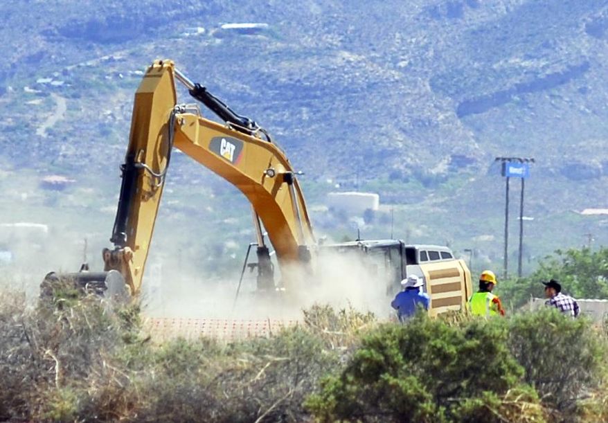 CORRECTS TO ALAMOGORDO FROM ALAMAGORDO - Crews begin digging at the old Alamogordo, N.M., landfill on Friday April 25, 2014, to search for copies of the Atari game "E.T. The Extraterrestrial" purportedly buried there in the 1980s. The game is considered among gamers to be one of the worst ever and is believed to have contributed to the demise of Atari. (AP Photo/Alamogordo Daily News, John Bear)