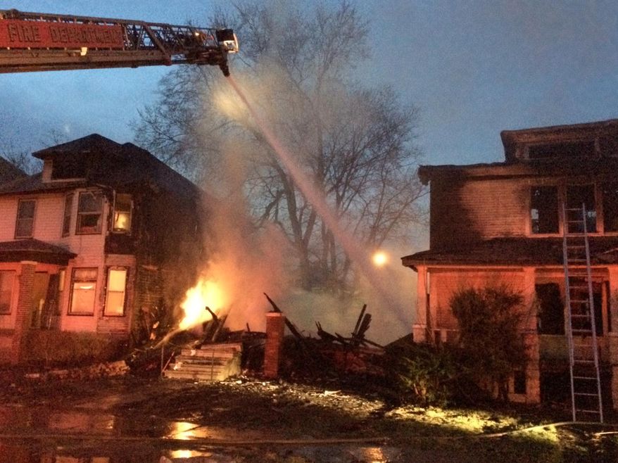 Firefighters battle a blaze that broke out around 3 a.m. in the 4280 block of Allendale, in Detroit, Friday, April 25, 2014, on a street littered with abandoned homes. The fire destroyed one house and burned at least two others nearby. No one was injured. (AP Photo/The Detroit Free Press, Robert Allen)
