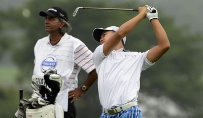 In this photo released by OneAsia,  Guan Tianlang of China plays a shot during the second round of the Volvo China Open at Genzon Golf Club in Shenzhen, southern China Friday, April 25, 2014.  Fifteen-year-old Guan, a year removed from his breakout performance at the Masters, failed to make the cut at the China Open on Friday, shooting a 76 to finish at 3-over 147. (AP Photo/OneAsia, Paul Lakatos) NO LICENSING